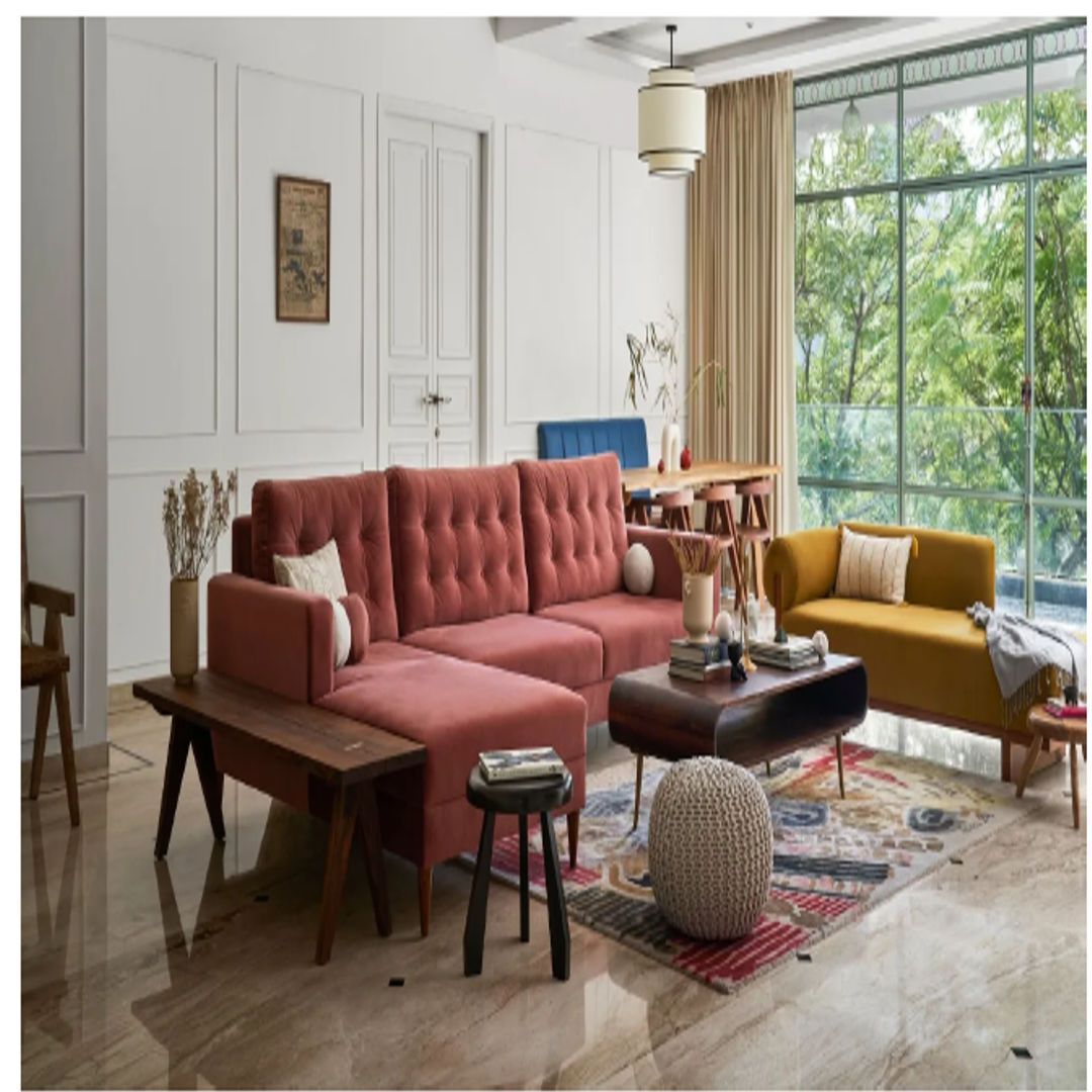 Architectural Digest and A circular Terrazzo table anchors the dining nook. Mid-century-inspired wood-and-cane chairs, accentuated with brass details, offer a tropical flourish. Interiors - PS Designs. Ishita Sitwala image